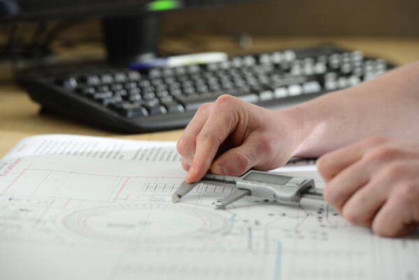 Dairymaster design engineer measuring up parlour design
